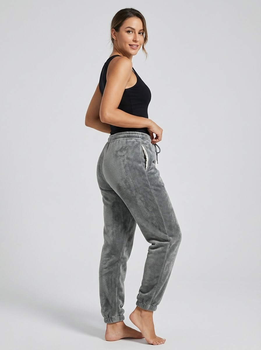 Model wearing ThermaTrack Sherpa-Lined Fleece Joggers - 3/4 angle view