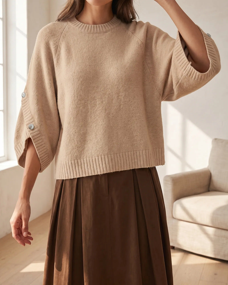 The Elodie sweater worn at home, the tulip sleeve open at the forearm