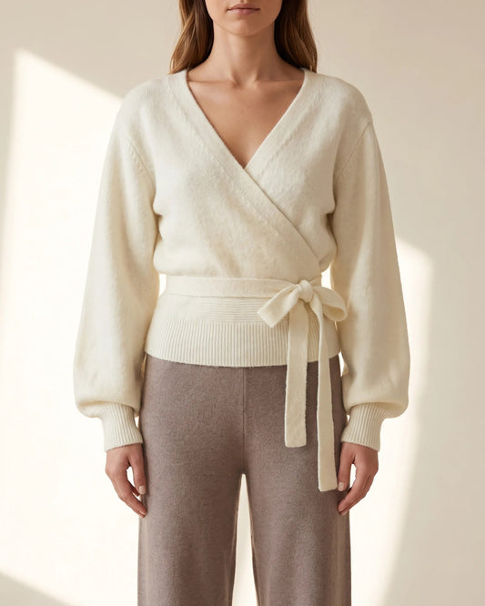 The Juliette Wrap Sweater in cream, worn with taupe wide-leg trousers