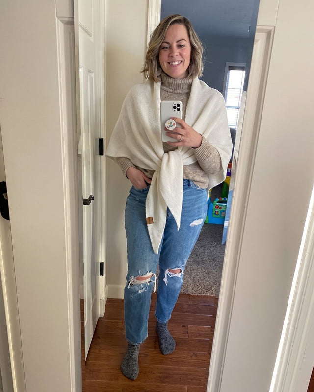 White Fleece Shawl knotted over a white top and jeans