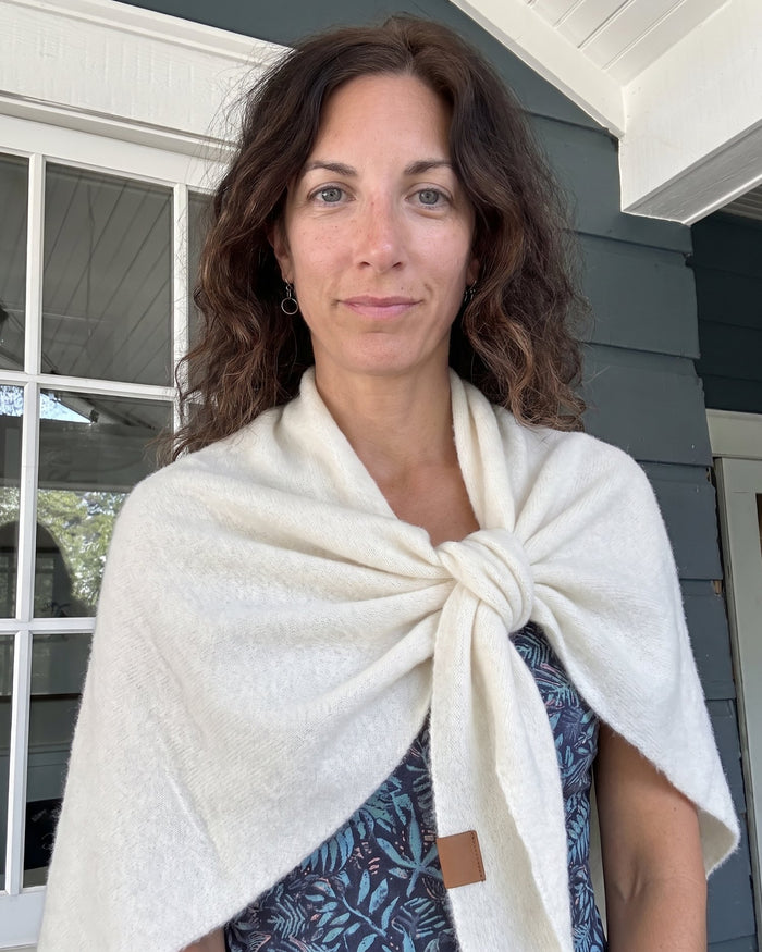 The Fleece Shawl knotted at the chest, worn on an autumn street