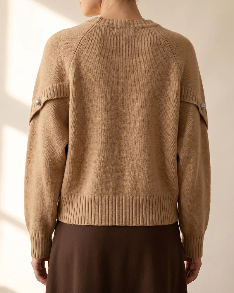 Back view of the sweater showing the sleeves gathered into ribbed cuffs