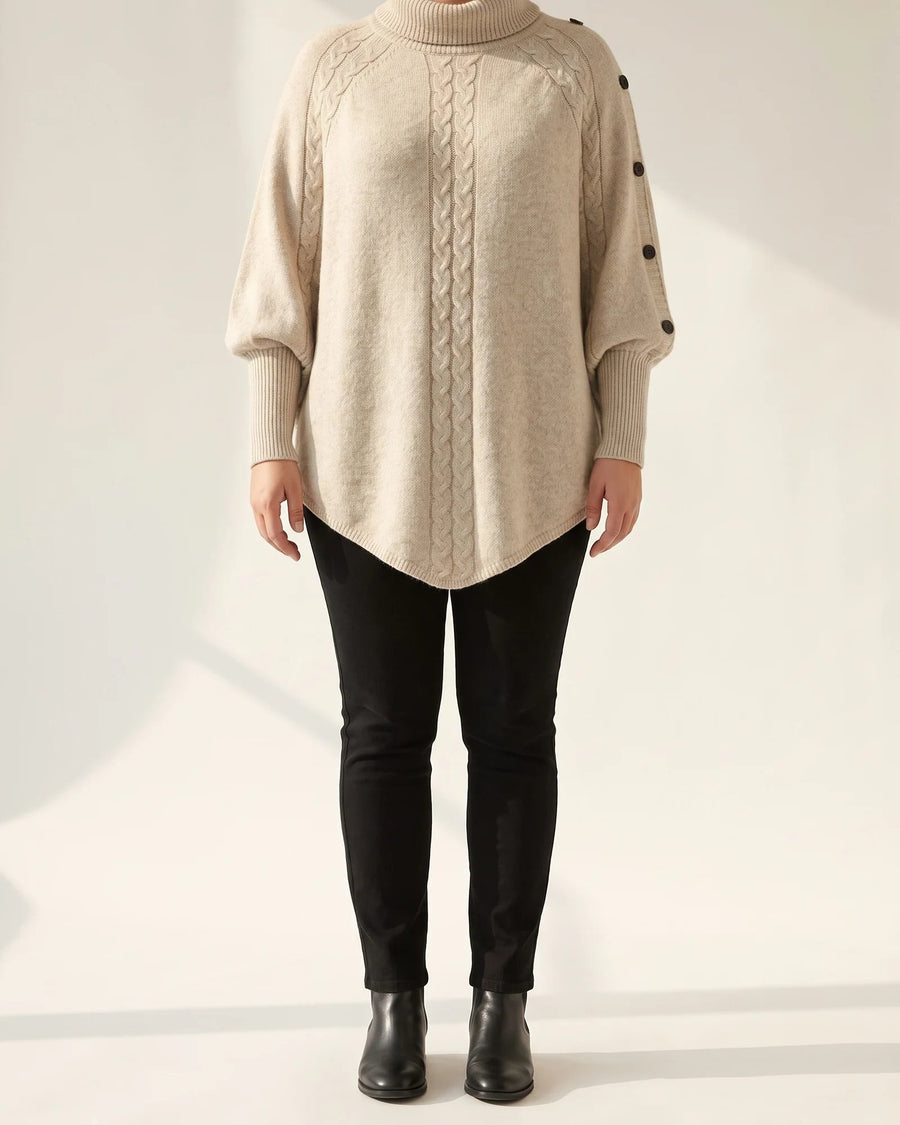 Oatmeal Nora poncho sweater with a slouchy turtleneck, centre cable and buttoned shoulder