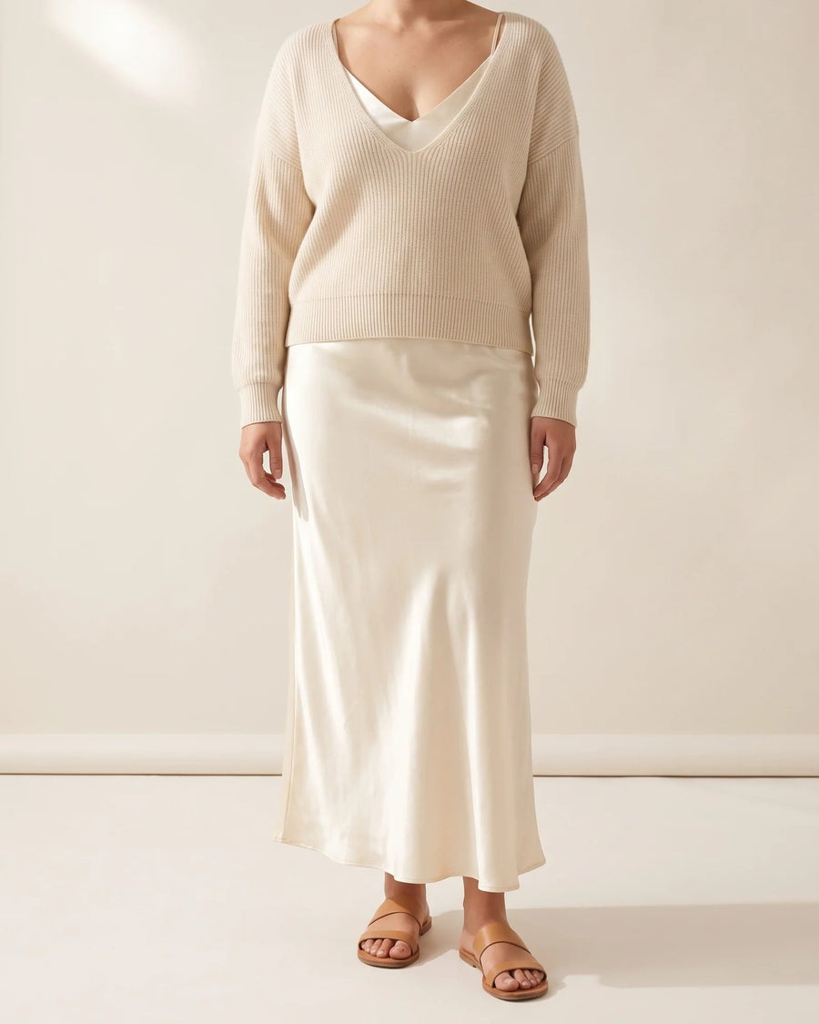 Apricot Sloane set: V-neck rib knit sweater over an ankle-length satin slip dress